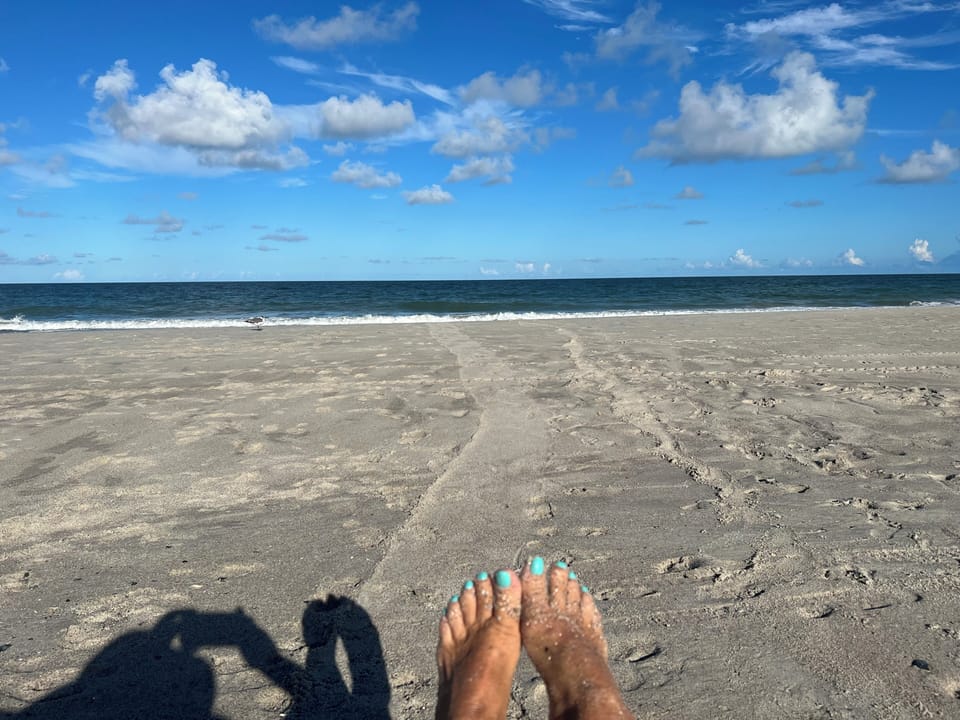 Toes painted and in the sand