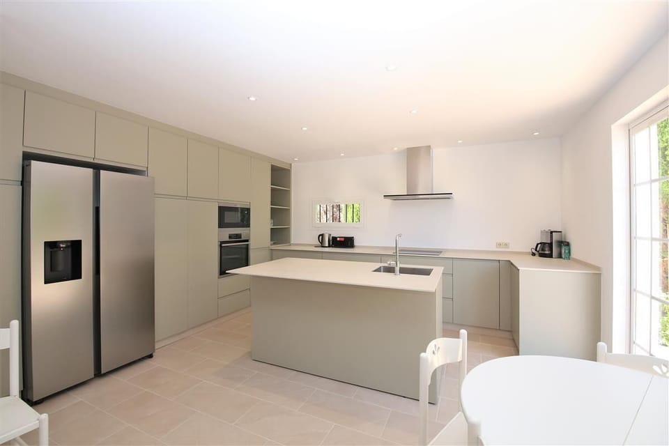 Modern and spacious kitchen is fully equipped with quality appliances