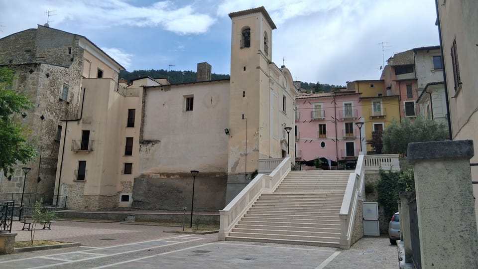 Steps from the square to the village centre. House on the left of the church