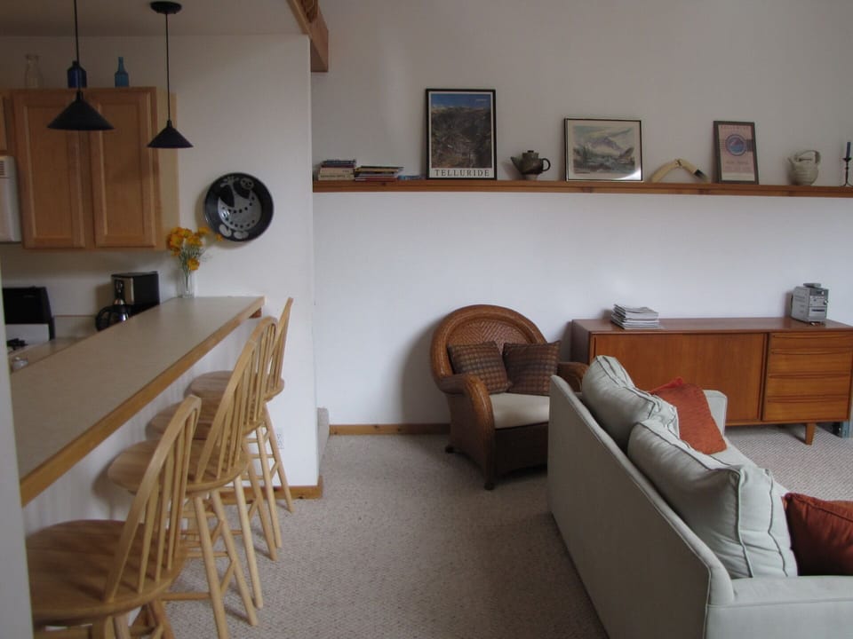 Living room open to kitchen, with counter seating.