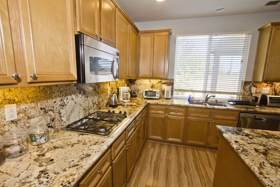 Kitchen w/ stainless appliances, granite counters and appliances required 