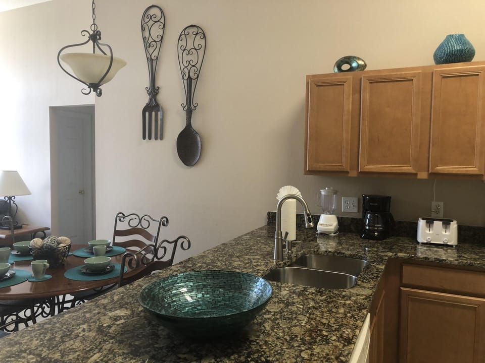 Granite countertops, double sink and gooseneck spray faucet