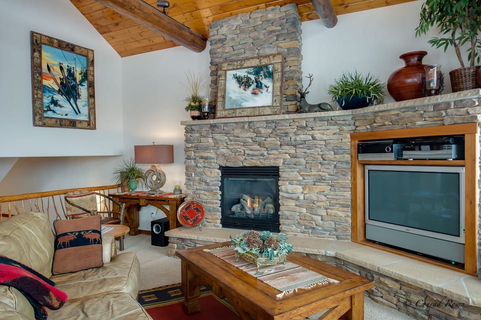 Stacked stone fireplace with flat screen tv and audio center