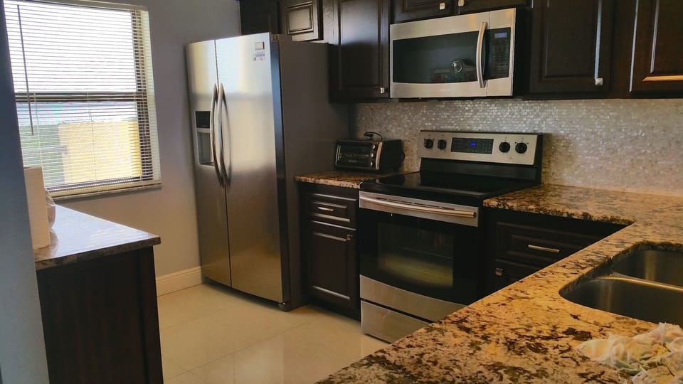 granite kitchen with stainless steel appliances 