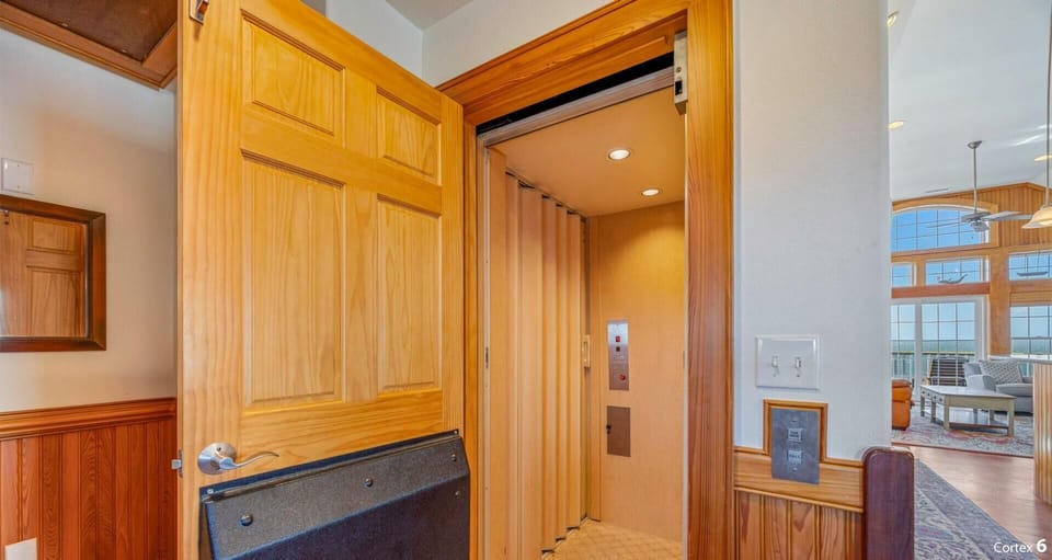 Your private elevator offers elegant wood-paneled access with modern convenience and sophisticated style.