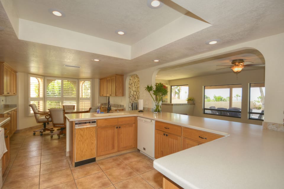 A big kitchen with equipped kitchen utensils and silverwares. 
