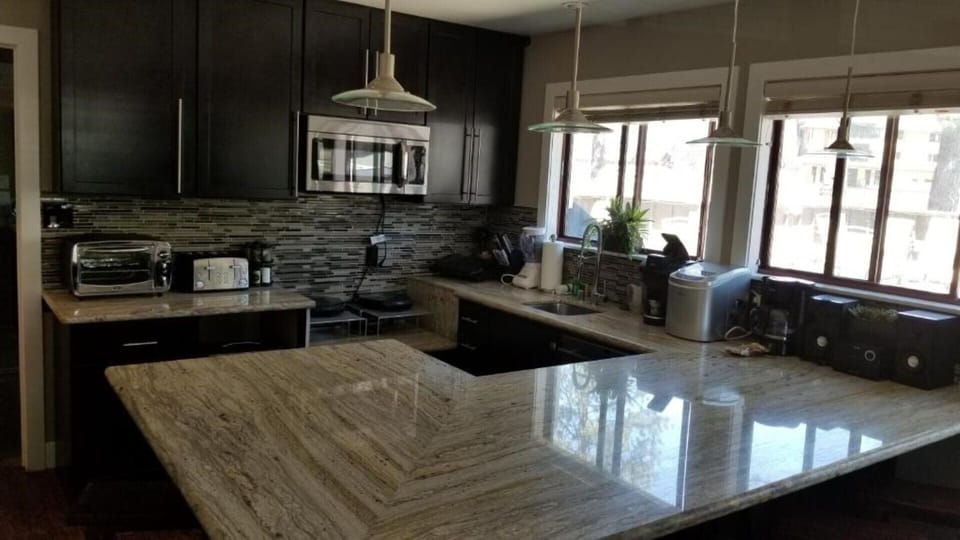 Large kitchen with bar. Dishwasher, 2 induction cooktops, combo microwave/oven