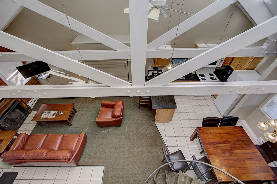 view of living room, kitchen from top of circular stairs