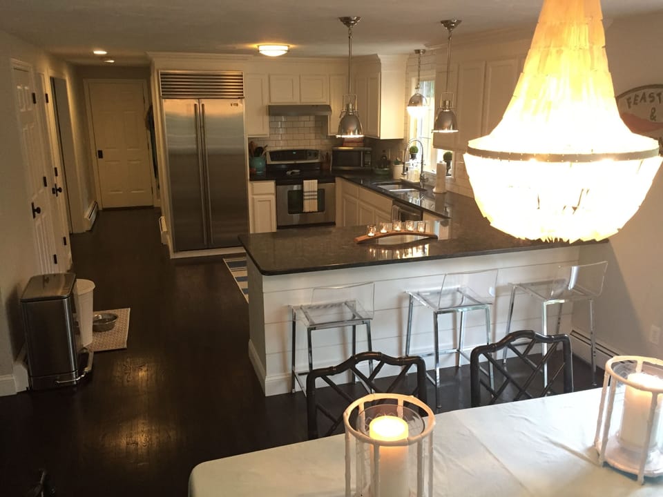 open kitchen with granite, pendant lights, subzero fridge, Wolf gas range 