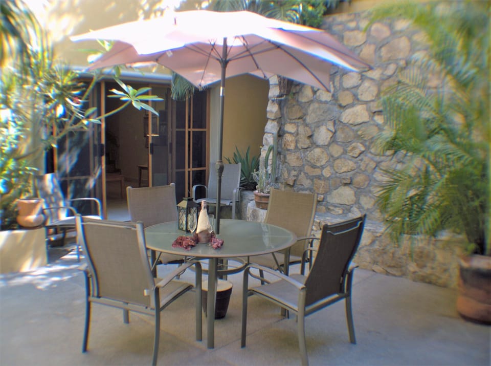 Shaded area outside apartment 2 with Table and chairs for outside dinning  