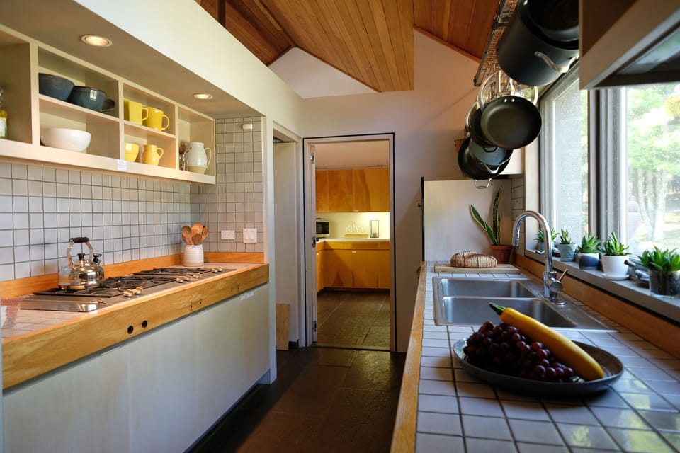 Gaggenau cooktop, double oven and a big pantry in a kitchen stocked for cooks.