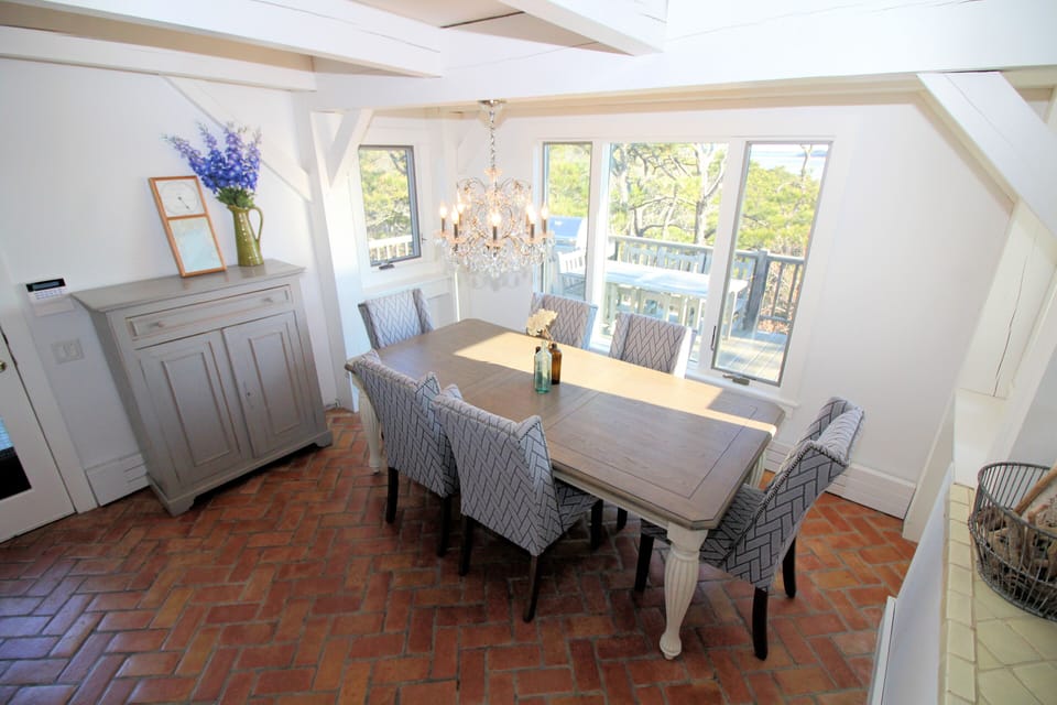 Lovely dining room overlooking deck and water beyond