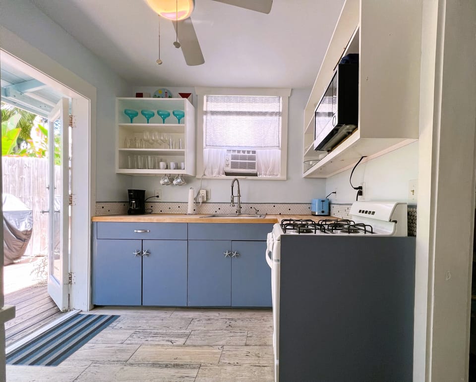 Bright kitchen with double French doors to back yard.