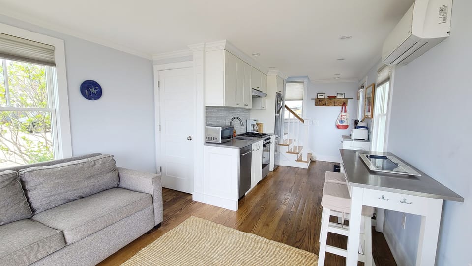 Living room with nicely equipped galley kitchen beyond