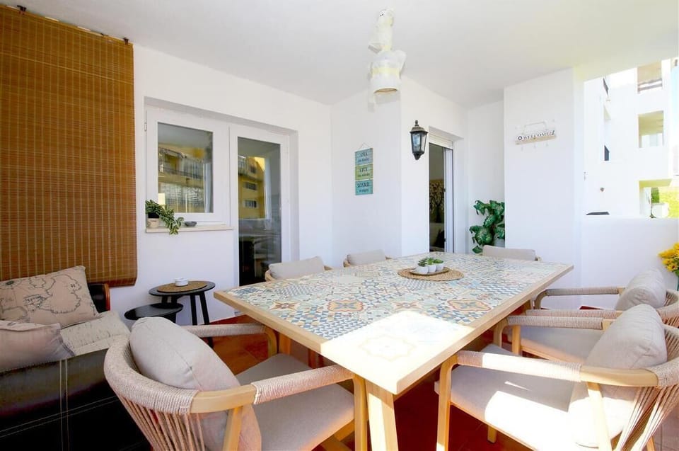 Spacious terrace with outdoor seating and dining area for six guests