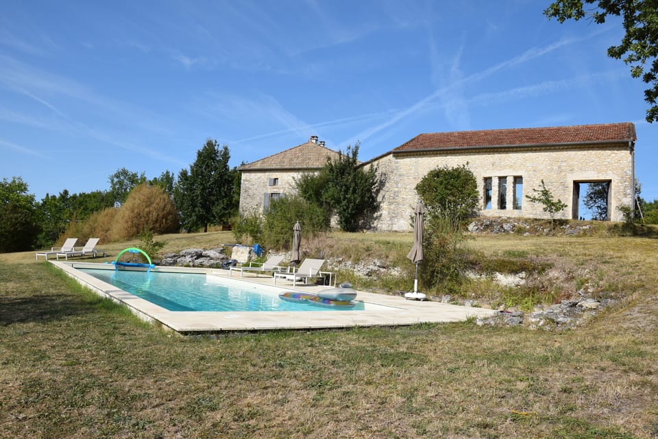 The pool with summer kitchen and house