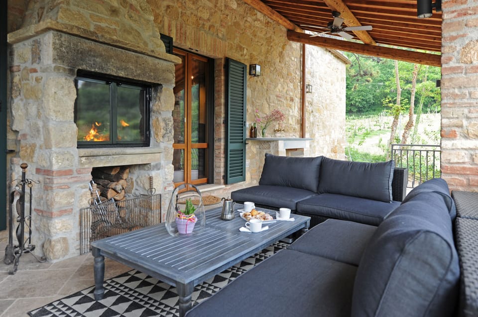 Seating around outdoor fireplace on the veranda
