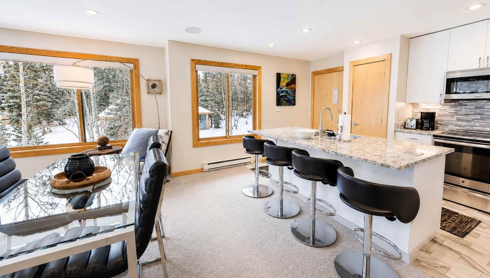 Gather with loved ones in this bright, modern space where granite countertops meet snowy mountain views. Sip your morning coffee at the breakfast bar while winter's beauty unfolds outside your windows.