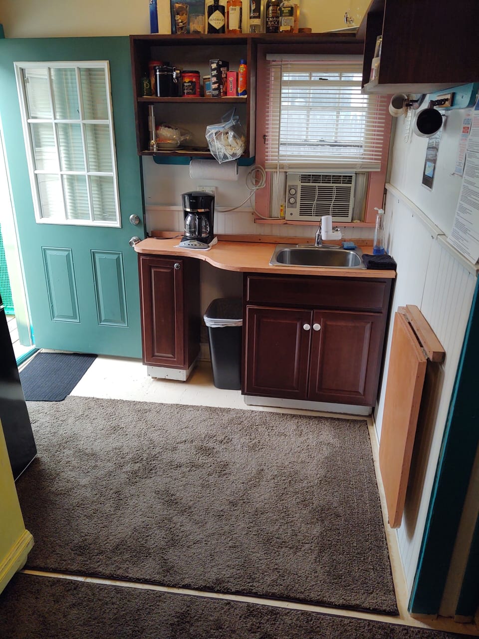 Refrigerator, Microwave Oven, Sink, Kitchen Cabinets, Silverware, Plates