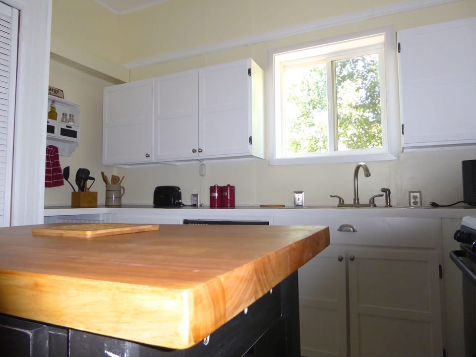 Kitchen butcher block island and window.