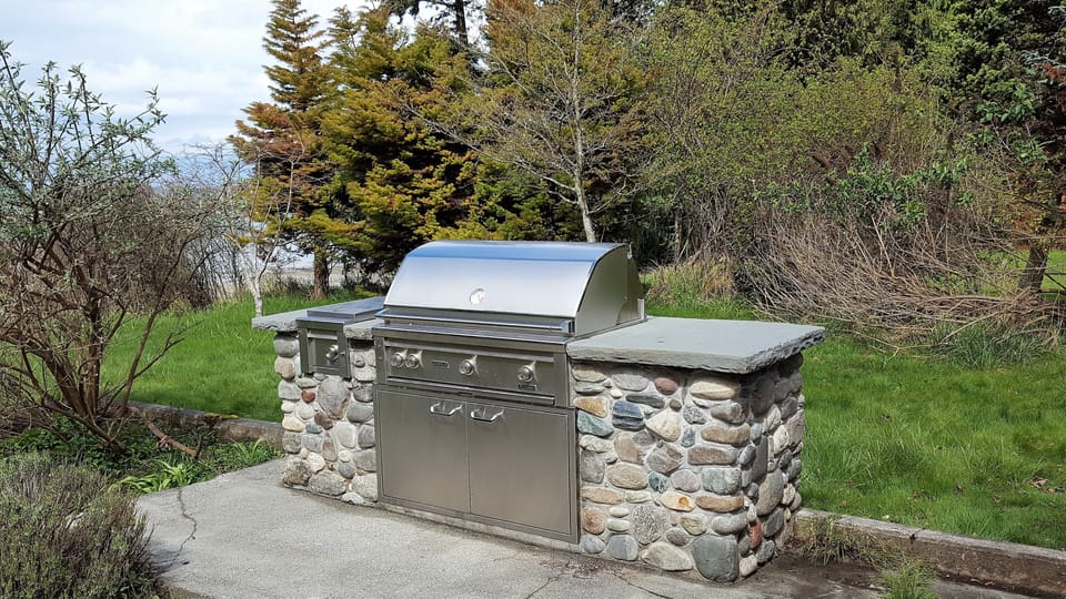 Gas BBQ with sunset views. The outdoor dining area has a table for 12