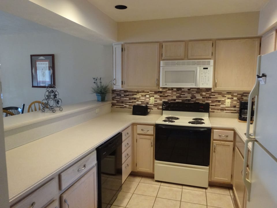 Kitchen with dishwasher, microwave, stove and fridge