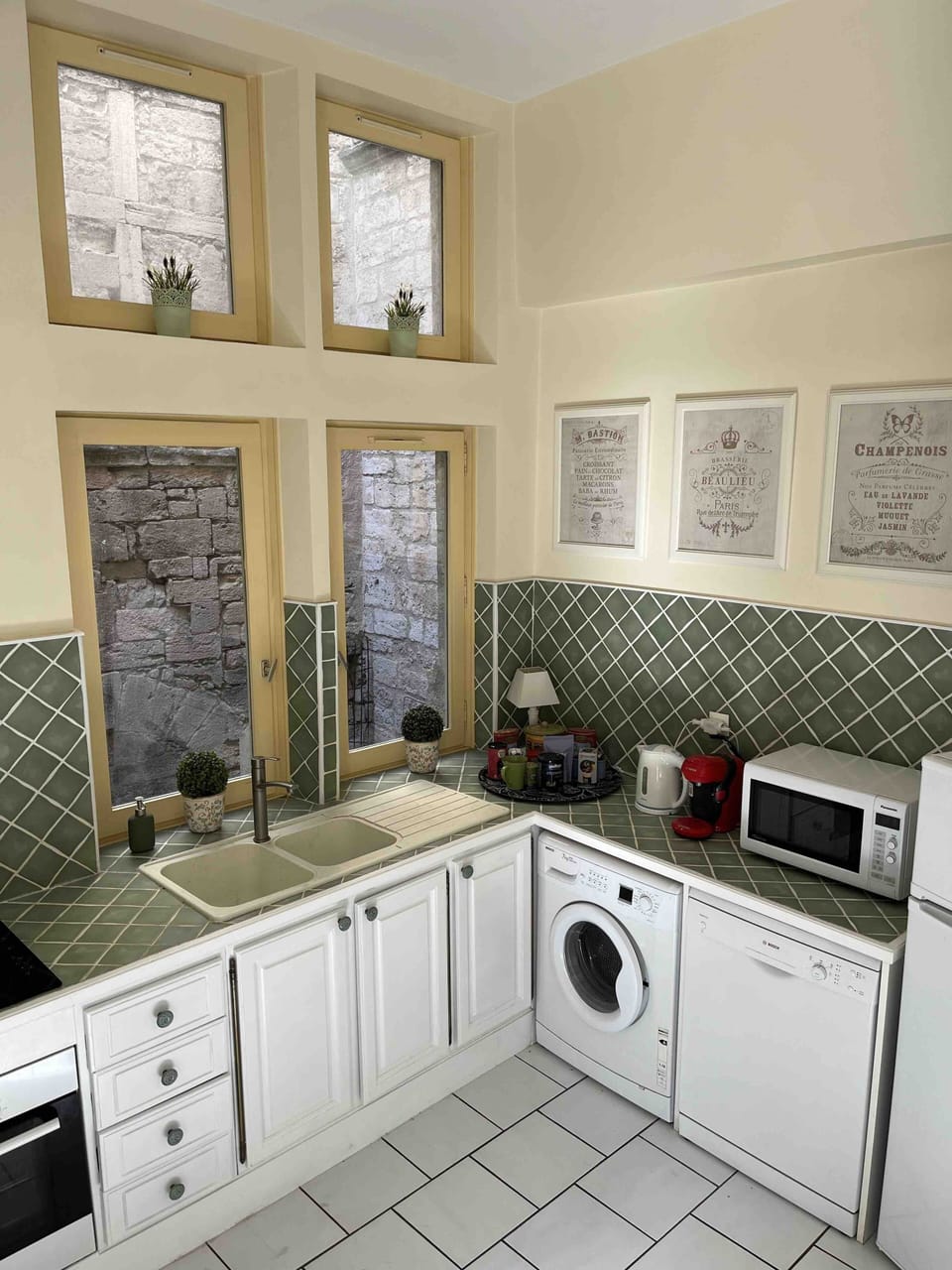 The sunny kitchen looks out over the 15th century atrium.