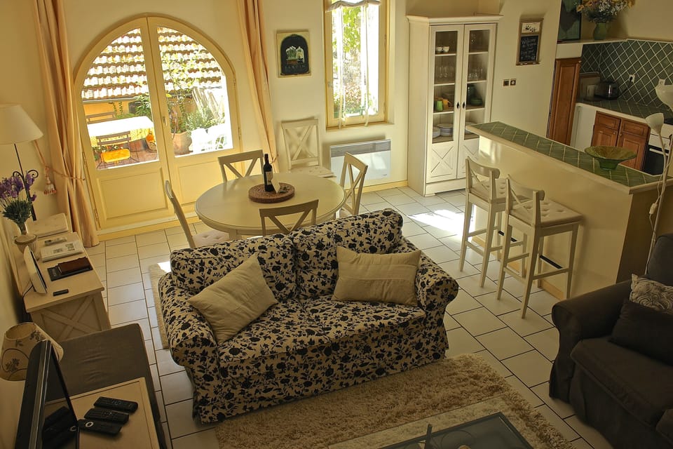 The cozy living room overlooks the dining area and kitchen.