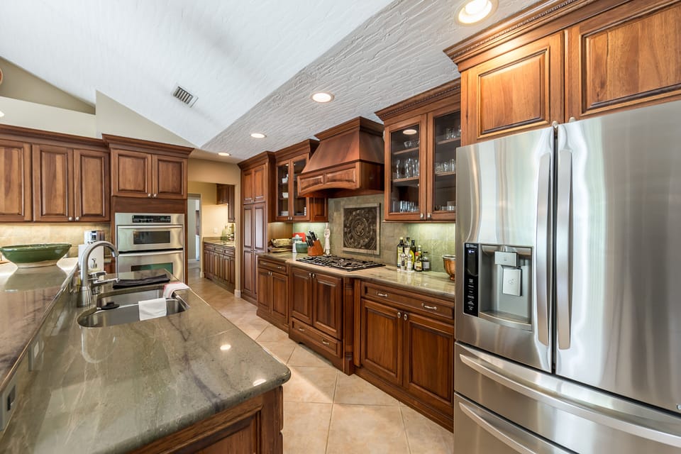 Lots of granite counter space, extra frig in garage. Light and airy.