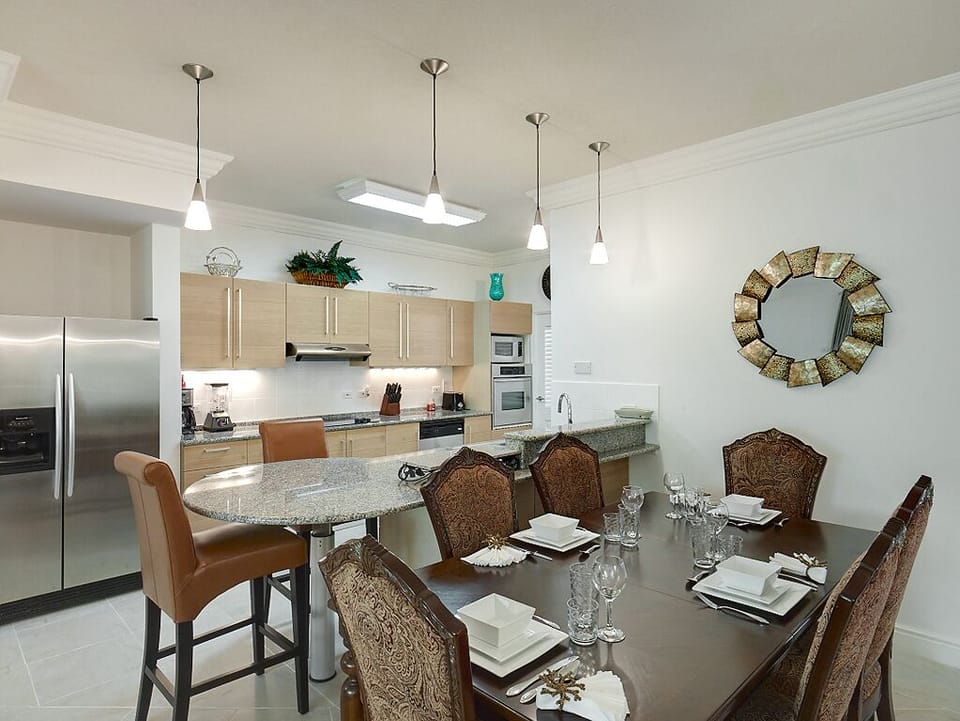 The dining table has seating for six, and two chairs at the breakfast bar