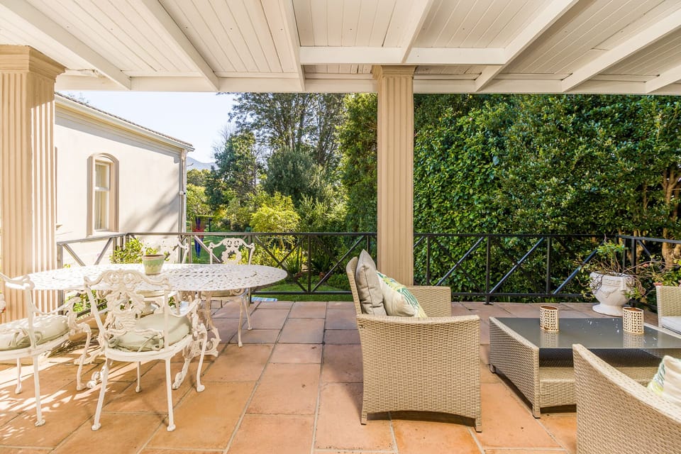 Patio with dining area sitting area leading onto private garden