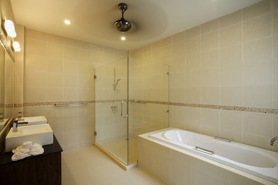 Bedroom 3 bathroom large en-suite bathroom with bath, walk-in shower and twin wash basins