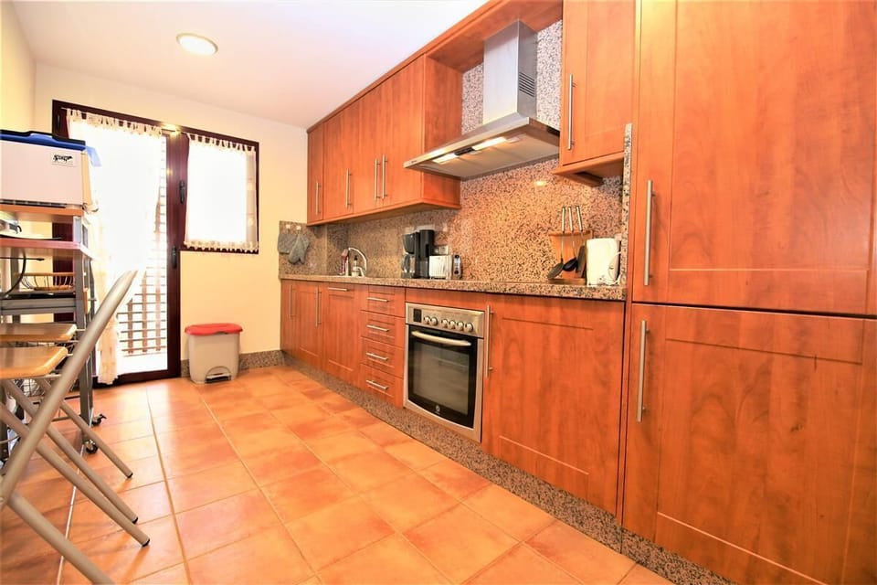 View of the fully equipped kitchen with laundry room to the rear