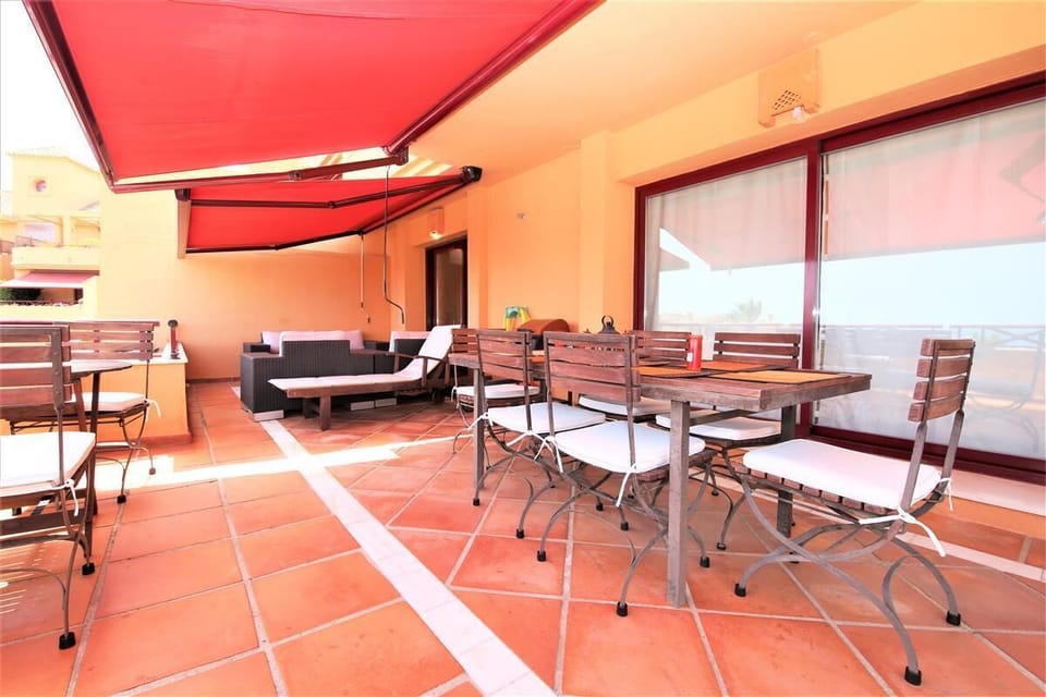 Full view of the apartment balcony with dining and BBQ area with plenty of seating