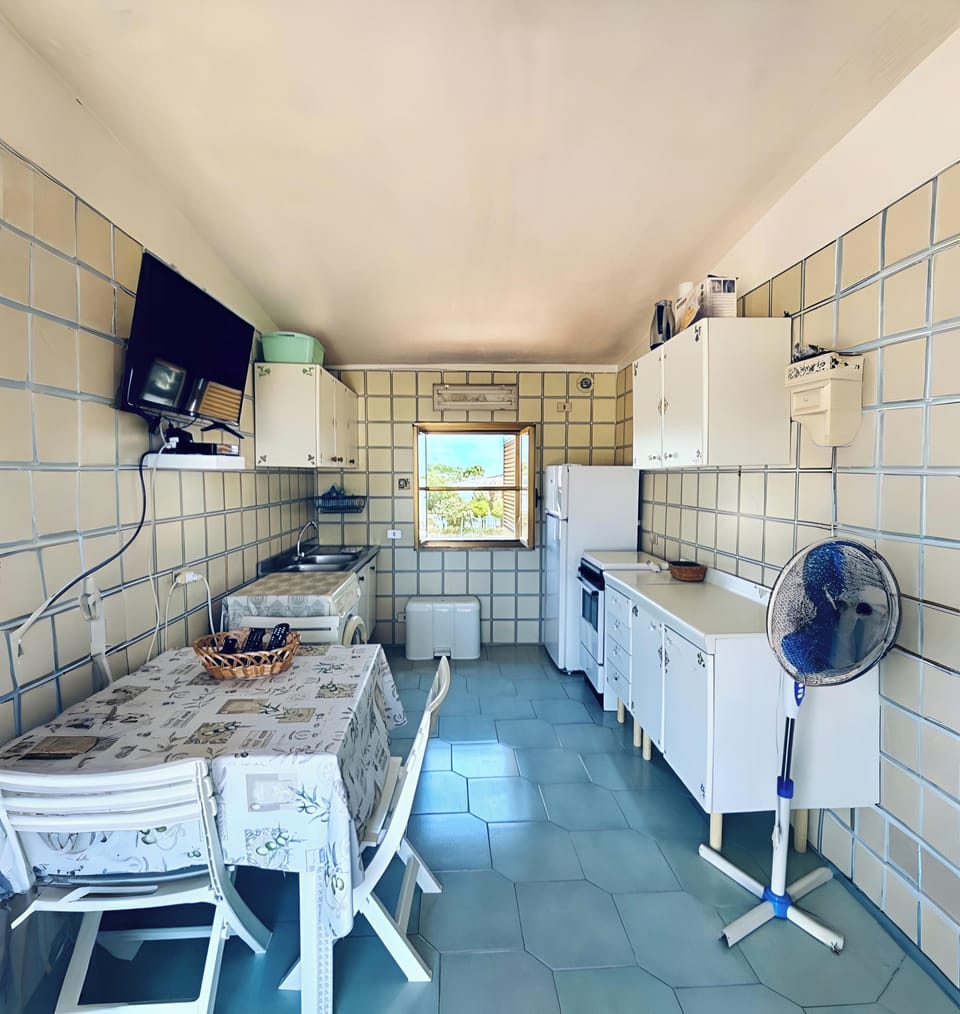 Kitchen with table,washing machine,fridge,freezer,smart Tv,cooking accessories