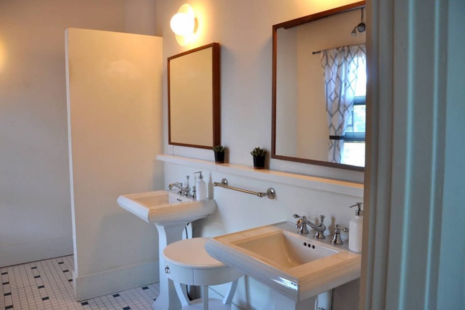 Master bathroom with two sinks, bathtub, and shower