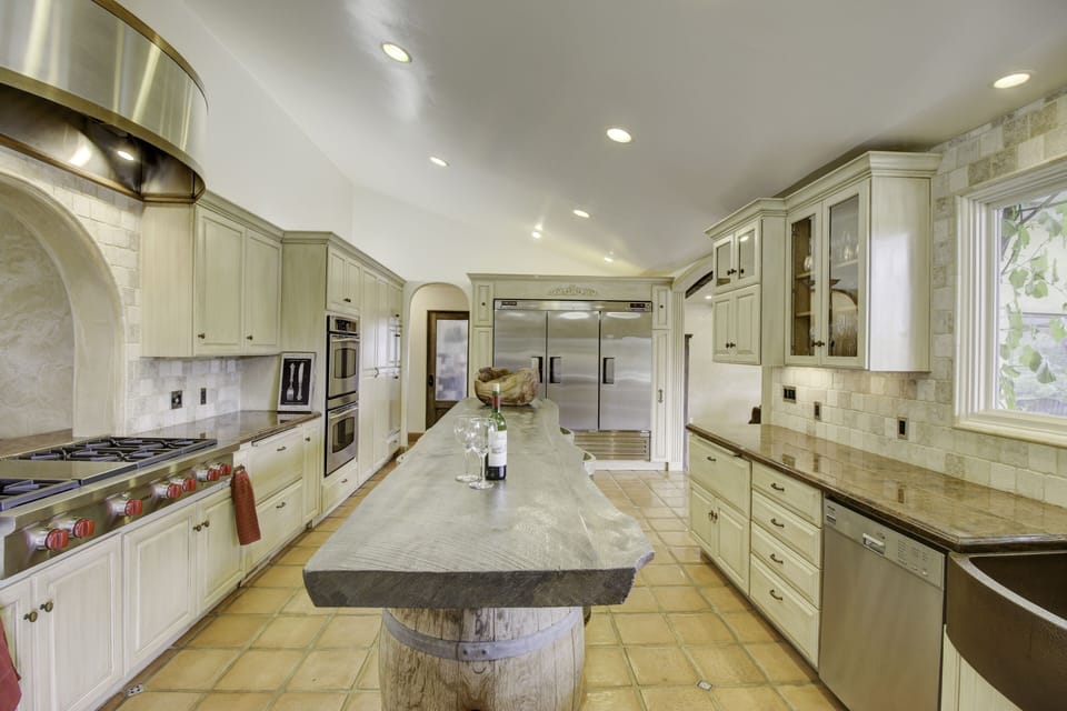 Chef's kitchen featuring Wolf stove, double oven, commercial fridge system