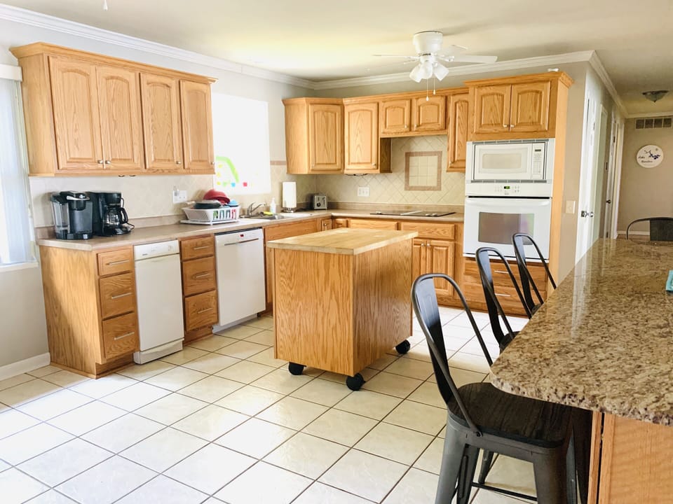 Kitchen has plenty of counter space and is well stocked for your cooking needs. 