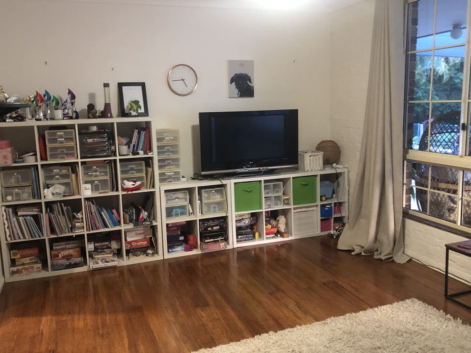 2nd living space with TV, reclining chairs, books, toys, wii and games