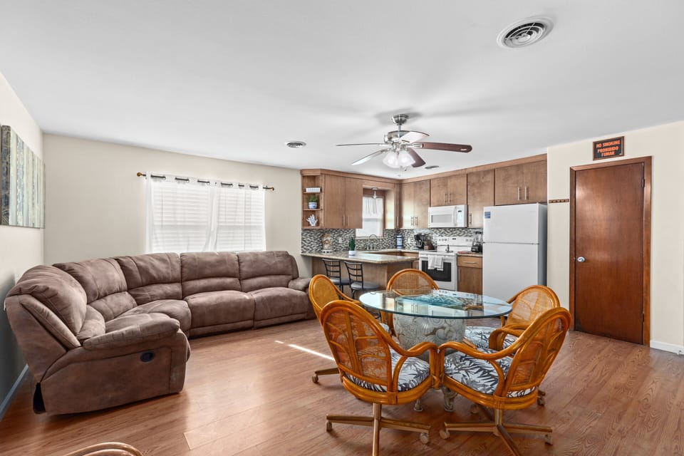 First unit open concept kitchen, living and dining. 
Please note furnishings and décor may vary slightly from photos; the large sectional sofa is not currently included in 116 Campeche #1.