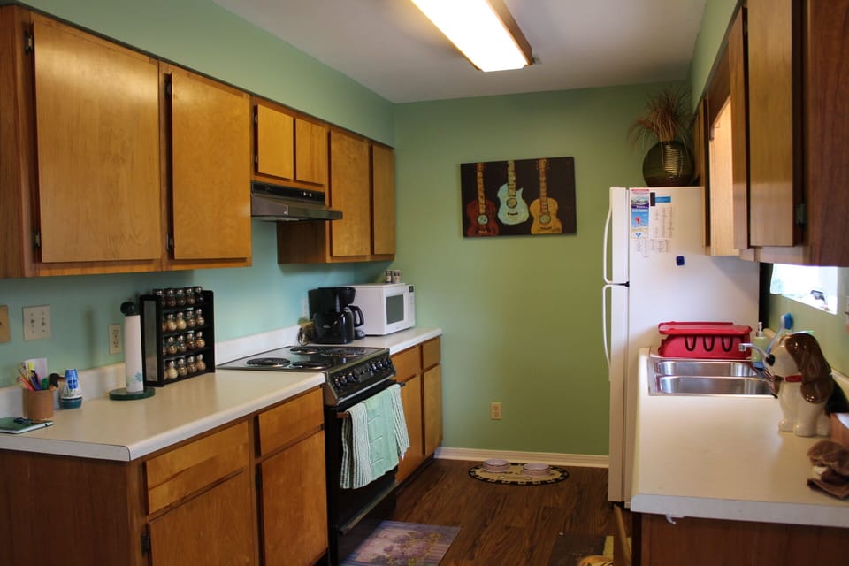 Kitchen with all appliances, plates, silverware, glassware, pots and pans.
