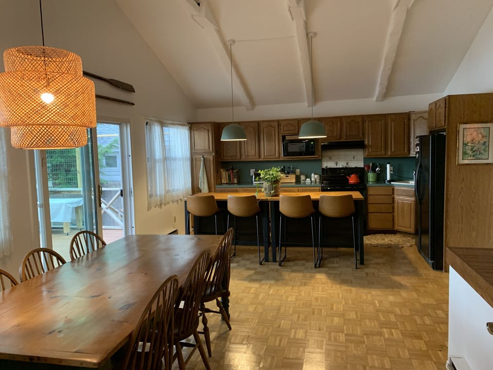Open-plan kitchen and dining room. Table seats 8 and kitchen island seats 4.