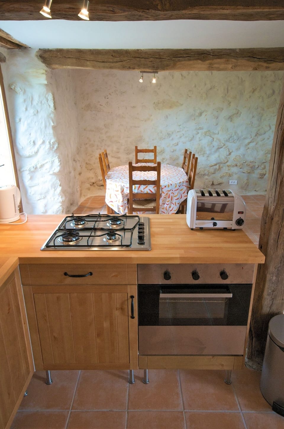 Part of the Vue des Montagnes Kitchen with dining area behind