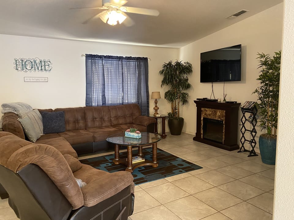 Living room with sofa & recliner 55 in tv & fire place