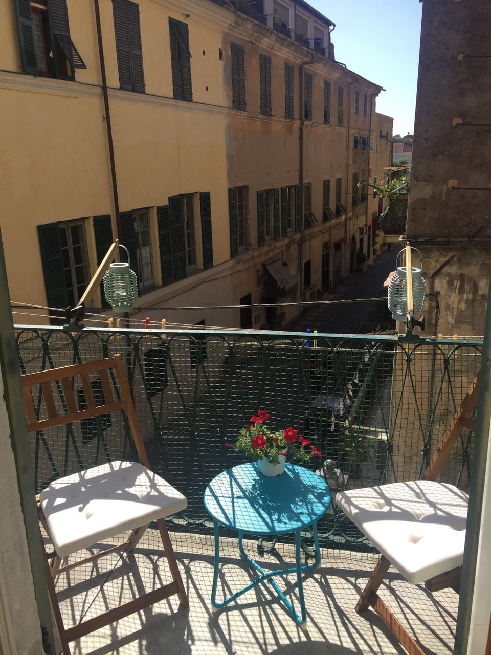 Balcony with outdoor furniture and clothesline.