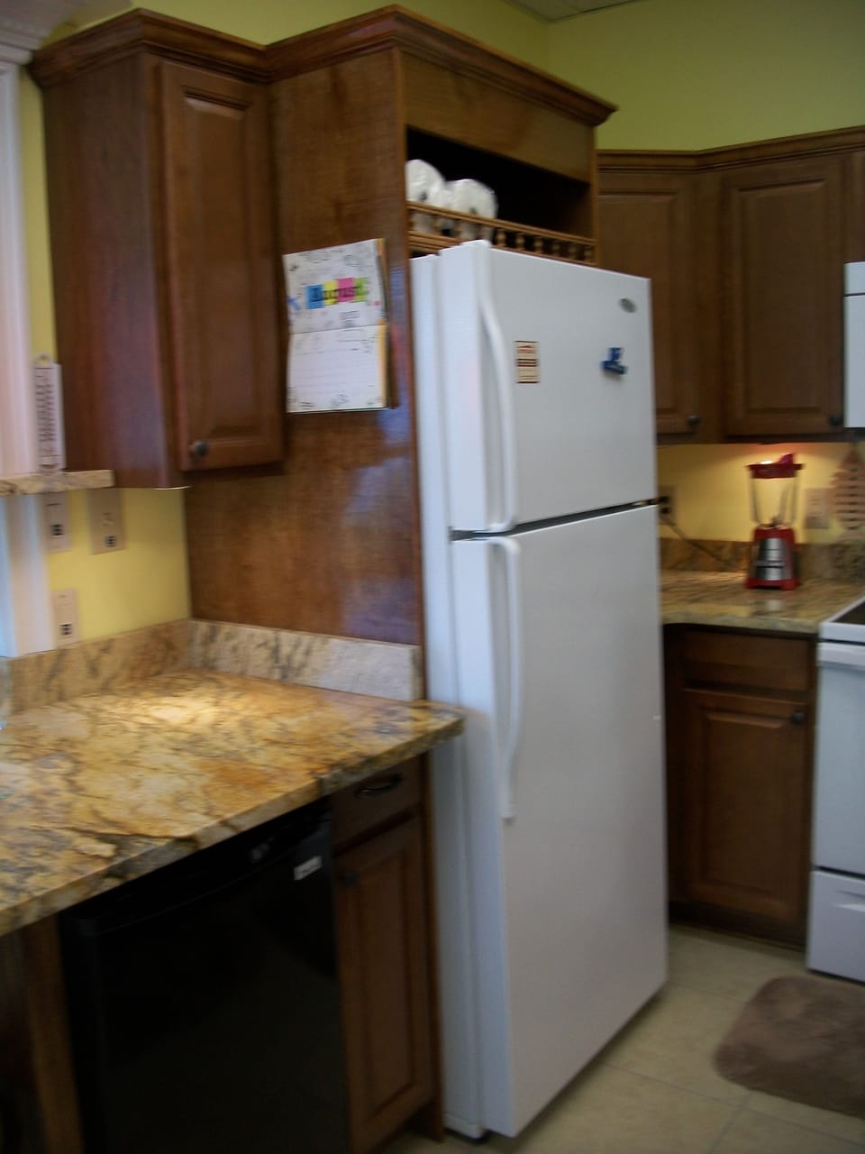 Opposite view of kitchen with tall refrigerator  and wine fridge under counter