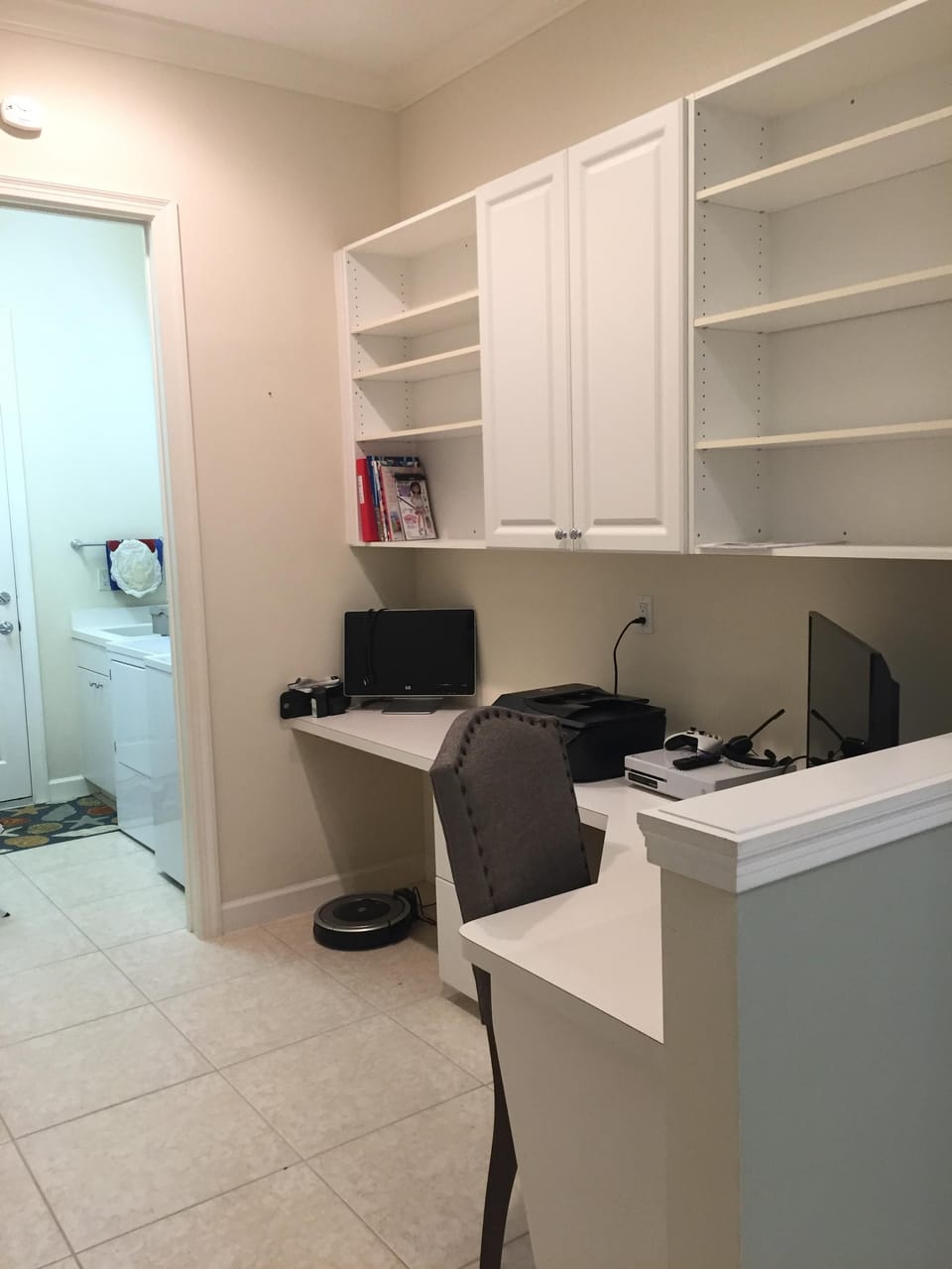 Office area with printer and monitor - leading to utility room
