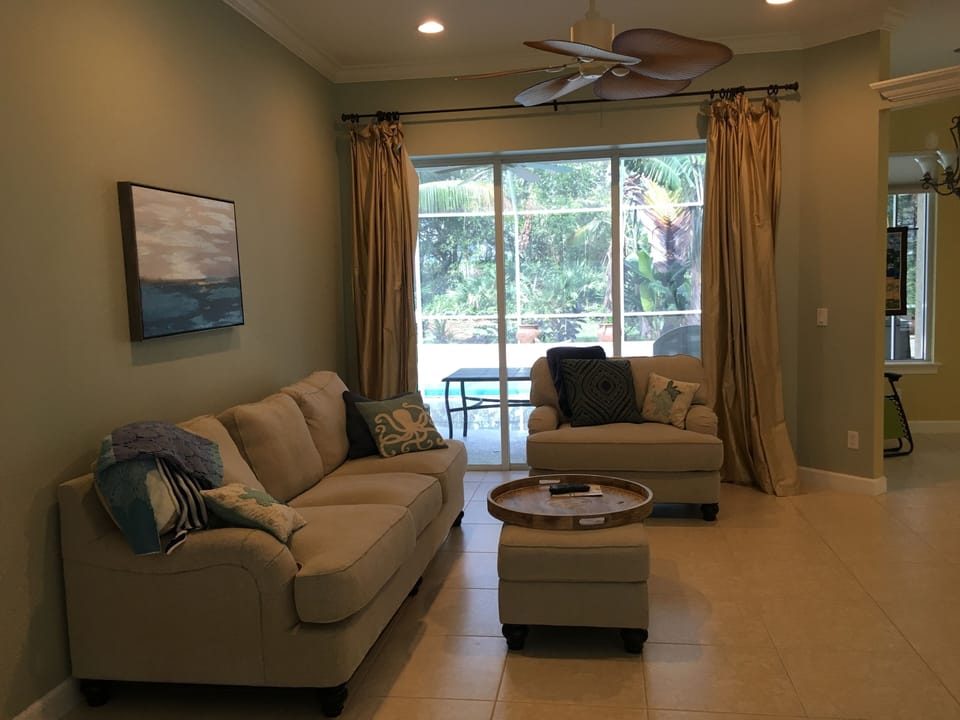 Open plan living area with sliders to patio/pool