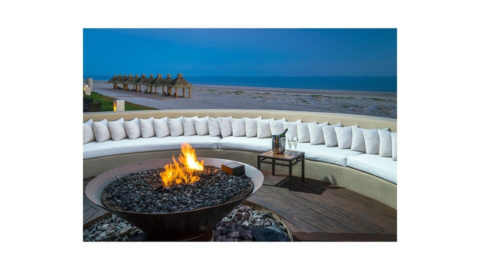 Fire pit at dusk overlooking beach and Sea of Cortez.