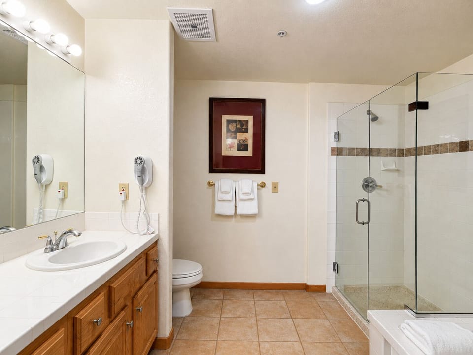 Spacious master bathroom with walk-in glass shower and large vanity